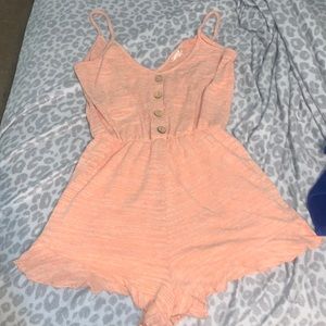 Altard state small peach romper with ruffles.